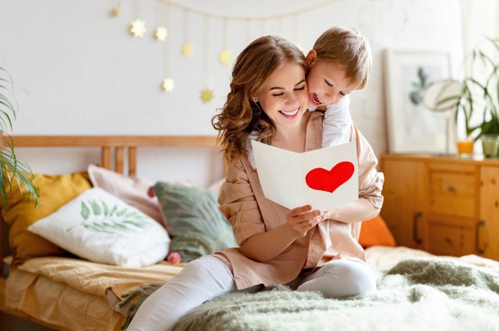 Mother and son reading greeting card